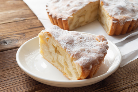 Slice of delicious apple pie on a white plateの写真素材