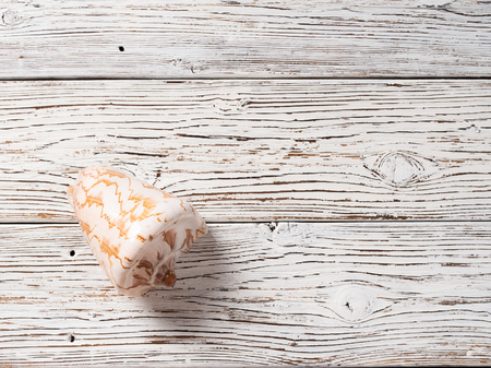 Big beautiful seashell on a white wooden background.の写真素材