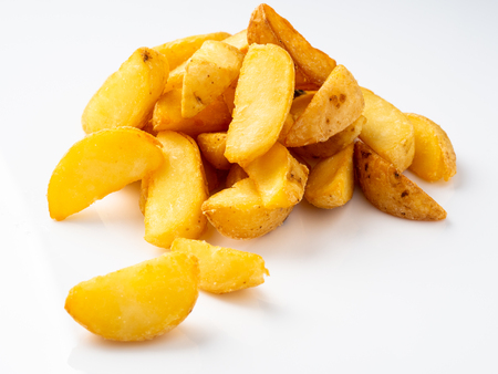Fried potato wedges on a white background.の写真素材