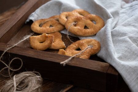 Sugar pretzels on a wooden trayの写真素材