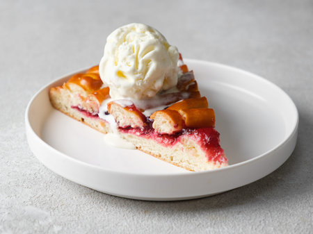 Piece of raspberry pie with ice cream on a light background