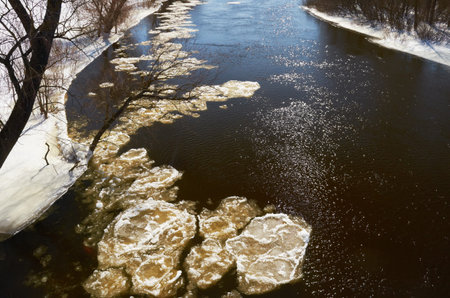 Winter river Chunks of ice floating on the river in winter