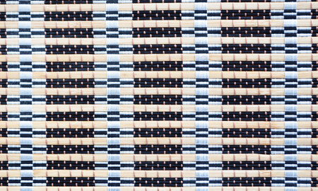 Background of interwoven sticks colored thread
