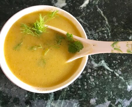 A bowl of soup and spoonの素材
