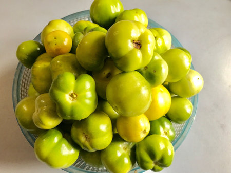 A container of green tomatoes