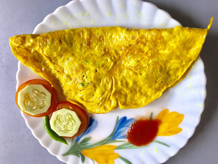 An omelette with salad and sauce