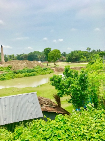 A beautiful natural scenery with pond and trees in a villageの素材