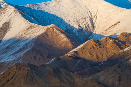 Sunset light illuminates layering mountain range at Leh Ladakh, Indiaの写真素材