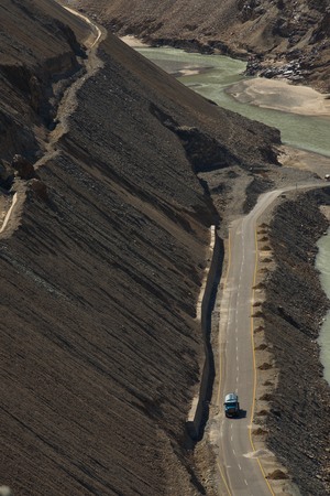 truck running along river and mountain, Leh Ladakh, Indiaの写真素材