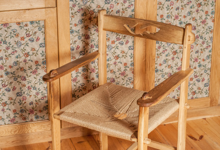 vintage wooden chair on a background of an old cabinet in high quality の写真素材