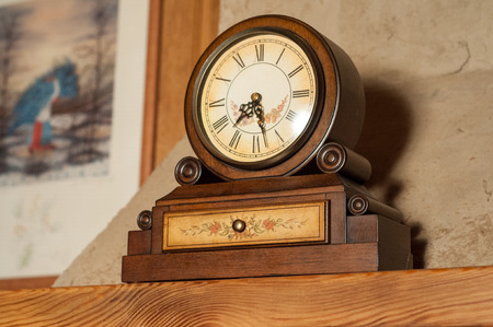 Vintage wooden clock on the mantelpiece in high quality の写真素材
