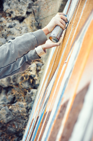 Boy painting graffiti close-up in high qualityの写真素材