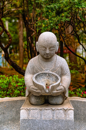 Statue of Buddha in the garden, Thailand. (Selective focus)