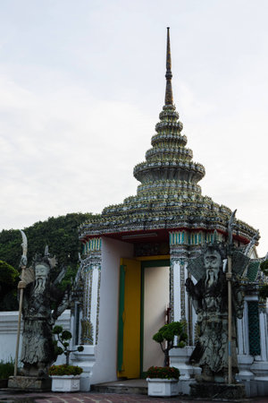 The stone Giant Guard at Wat Pho, Bangkok - Thailand with Blue sky on the background vertical.の写真素材