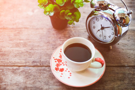 Start up concept.Coffe cup,alarm clock,notebook.morning coffee day start.