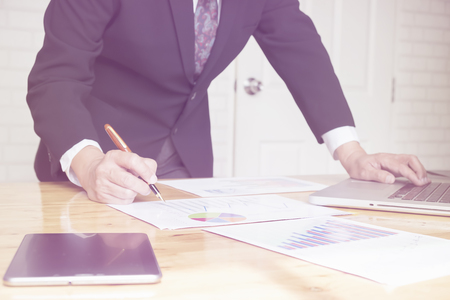 A businessman sign or discussing document or graph.Close up shot.Vintage or pastel effected photoの写真素材