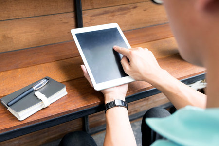 close up Asian man using tablet, laptop and cellphone connecting wifi