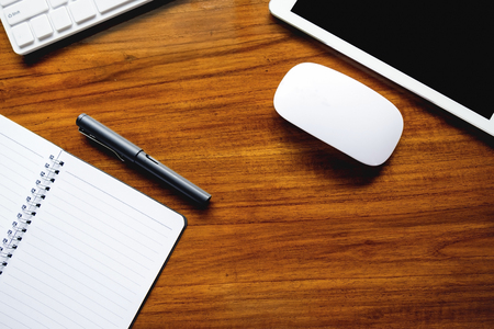 Flat lay photo of work desk with  pen, laptop, tablet, mouse, calculator and chart paper mock up.の写真素材
