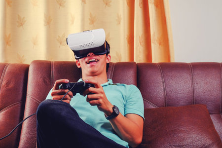 Young man using VR glasses playing a game