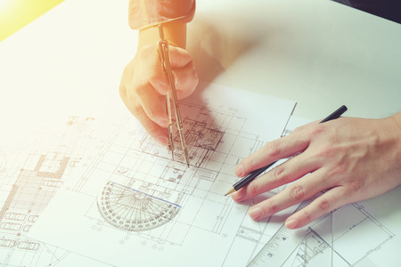 Close up man working of Architect sketching a construction project on his plane project at site construction workの写真素材