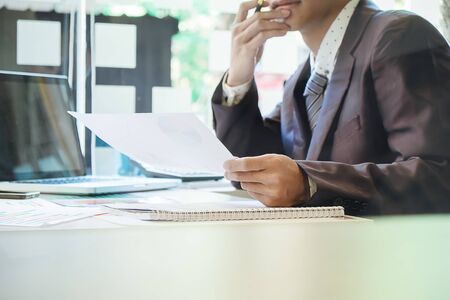 Asian Business man discussion and analysis data the charts and graphs showing the results at meeting. Business finances and accounting conceptの写真素材