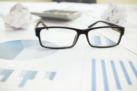 Eyeglasses on business and financial report. Accounting