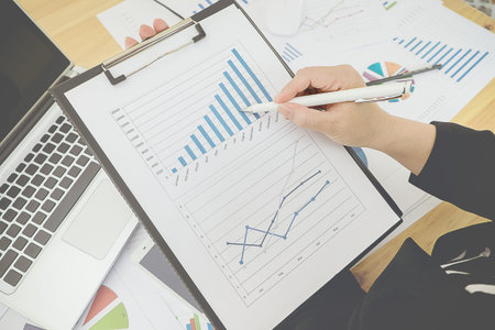 Asian Business woman discussion and analysis data the charts and graphs showing the results at...