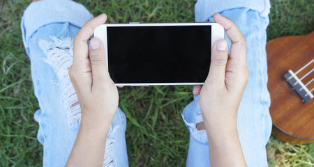 young women using hold phone from two hands