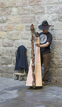 Barcelona, Spain - June 7, 2014 - A Catalan street musician performs in the Gothic Quarter in Barcelona, Spain  Catalan culture and music have become more popular with the Catalan movement in Spain のeditorial素材