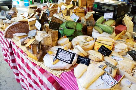 Display of cheeses at an outdoor market in Aix-en-Provence, Franceの写真素材
