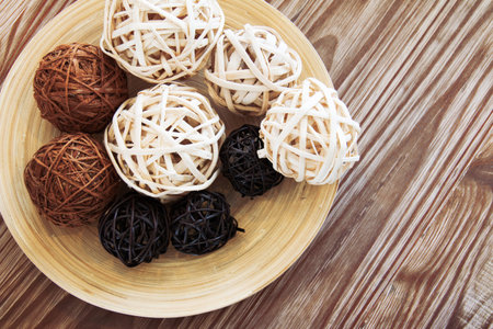 Rattan ball on wooden plate for decoration.の写真素材