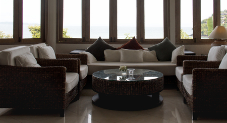 Low light living room. Wicker furniture set on living room.のeditorial素材