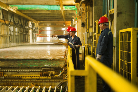 Zinc mine. Engineer cleaning machine in factory.のeditorial素材