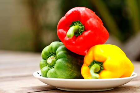 sweet peppers on white dishの写真素材
