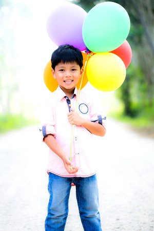 smile boy with colorfull ballonsの写真素材