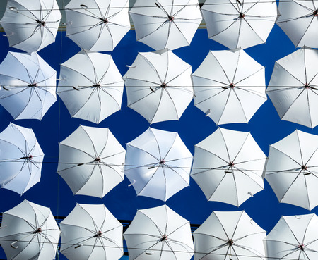 a group of  white umbrella  on bright blue skyの写真素材