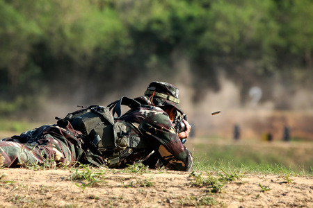 soldier is shooting rifle at goalの写真素材