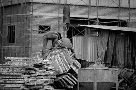 The crane driver is giving the crane for lift steel at construction siteの写真素材