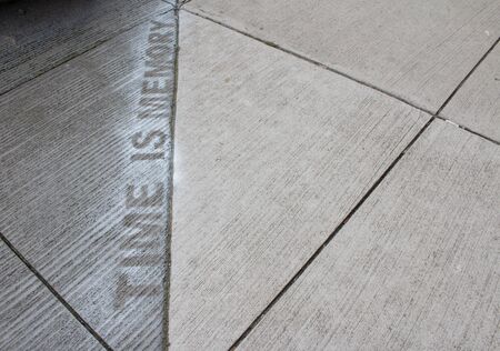 TIME IS MEMORY sprayed painted on a sidewalkの写真素材