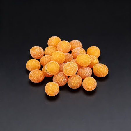Orange dried apricots on a black background. Studio shot.の素材
