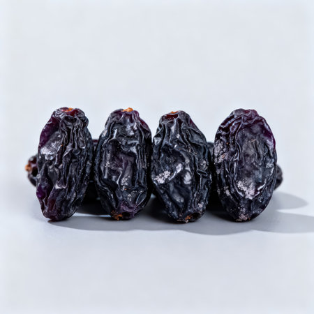 Black raisins on a white background. Close-up.の素材