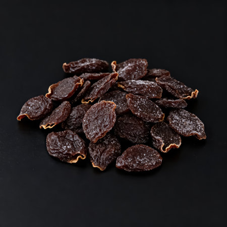 Heap of dried raisins on black background, closeupの素材