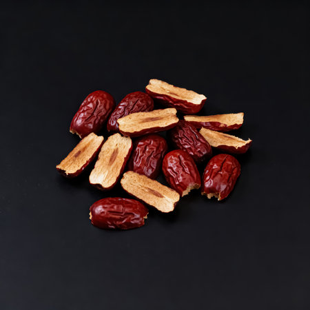 Dried red date fruits on black background. Top view. Copy space.の素材