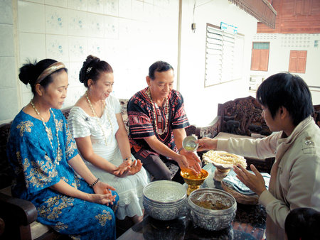 pour water on the hands of revered elders and ask for blessing in Songkarn festivalのeditorial素材