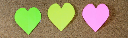 Three colors of Heart shaped memo papers with clips on board