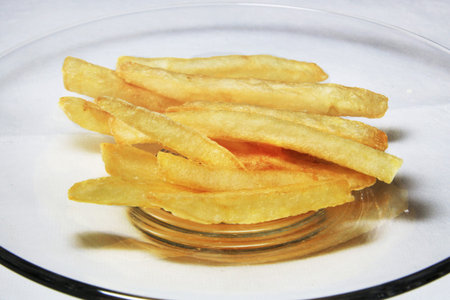 Potatoes fries in the plate isolated on white 