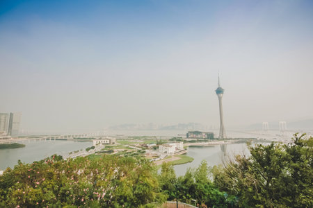 Macau tower in the cloundy day viewing from the top of Penha church in Macau city 