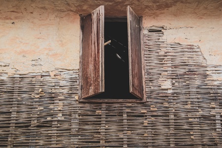 Old wooden window on the bamboo wall  Local house in Chaing Khan district in Loei province Thailandの写真素材