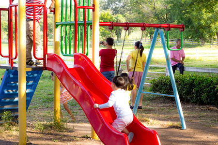 LOPBURI, THAILAND - DECEMBER 05  Chidren are playing at the playground in the garden on December 05, 2013 in Lopburi, Thailandのeditorial素材