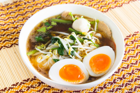 Thai noodle with meatball and boiled egg on table